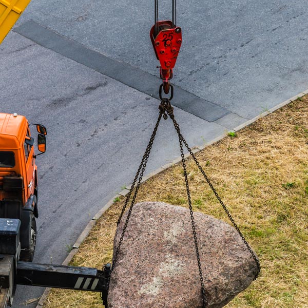 crane lifting heavy boulder